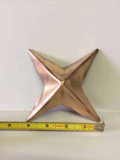 Image of Copper Star with measure tape show size of 4 inches.