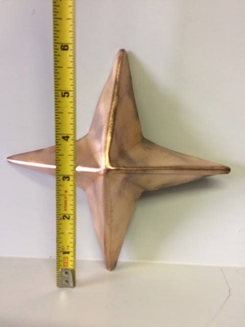 Image of Copper Star with tape measure showing height of 6 inches.