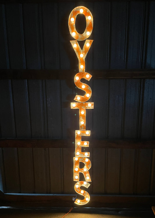 Image of letters spelling the word "Oysters" in a lit sign.